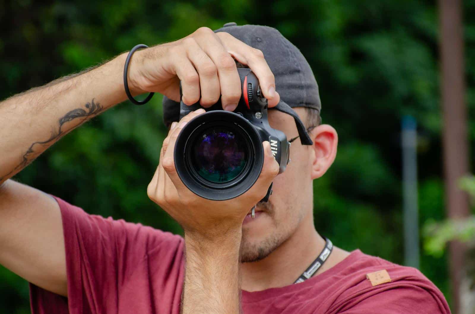 Image Compression, A photographer focuses on the lens outdoors in Porto Feliz, Brazil.