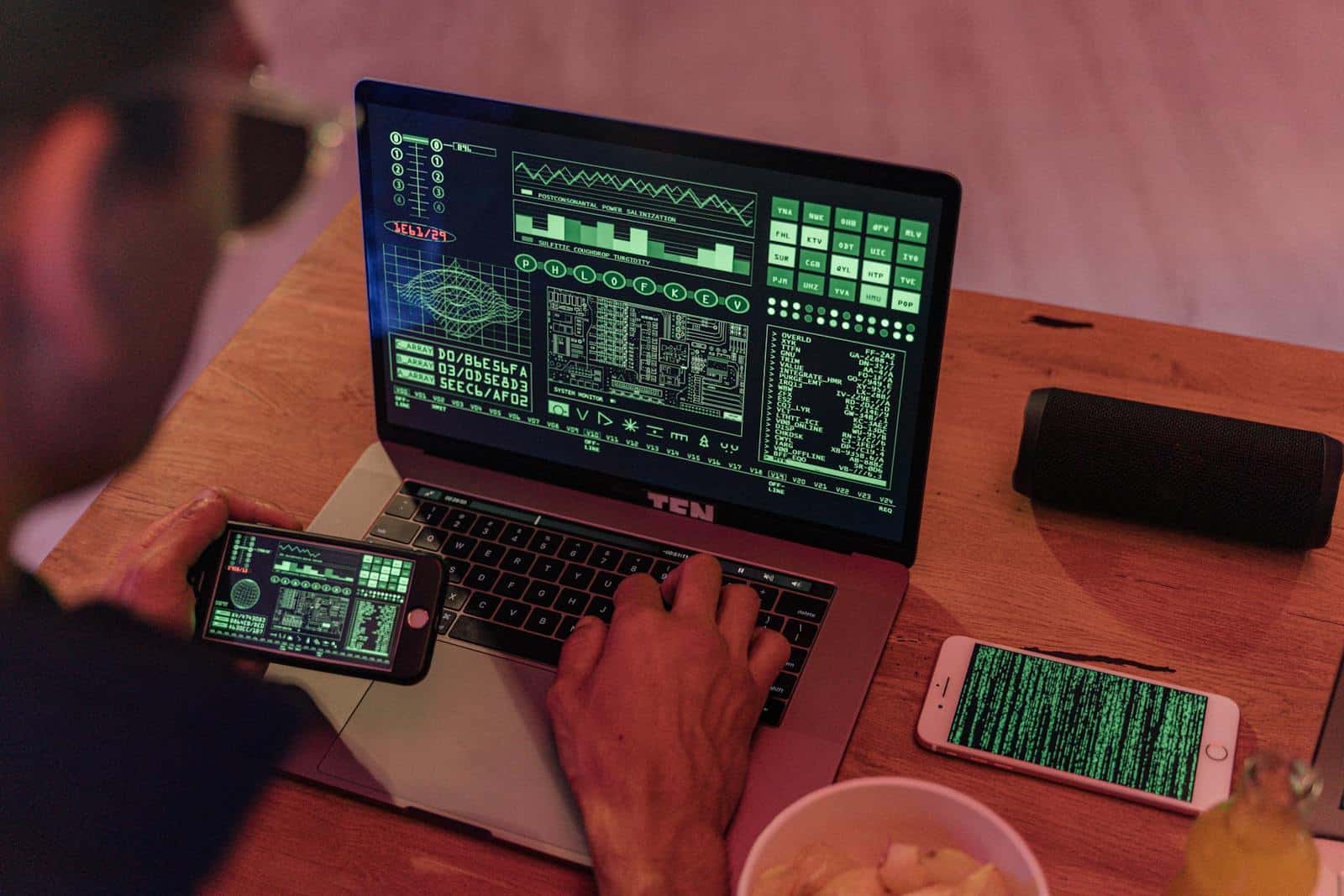 Encryption, Data Security, Man working with cybersecurity software on laptop and smartphone.
