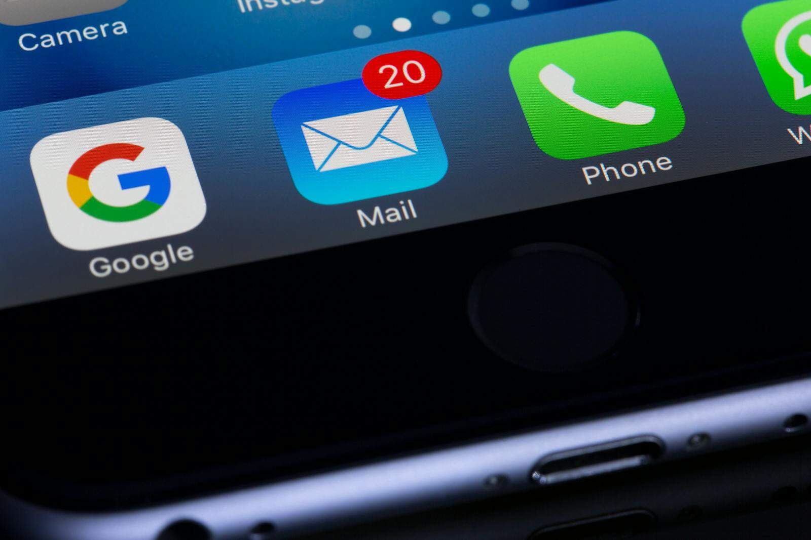 Email Deliverability, A close-up photo of a smartphone displaying popular apps like Google and Mail.