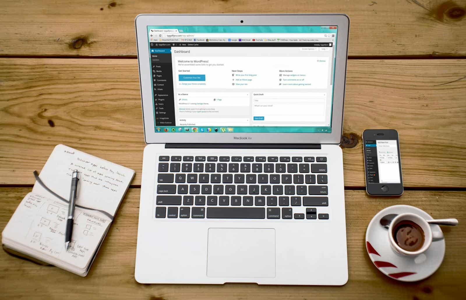 Managed WordPress Hosting, Website, Development, Agency Hosting, Fast Website, A cozy home office scene with a laptop, notebook, smartphone, and coffee, perfect for productivity.