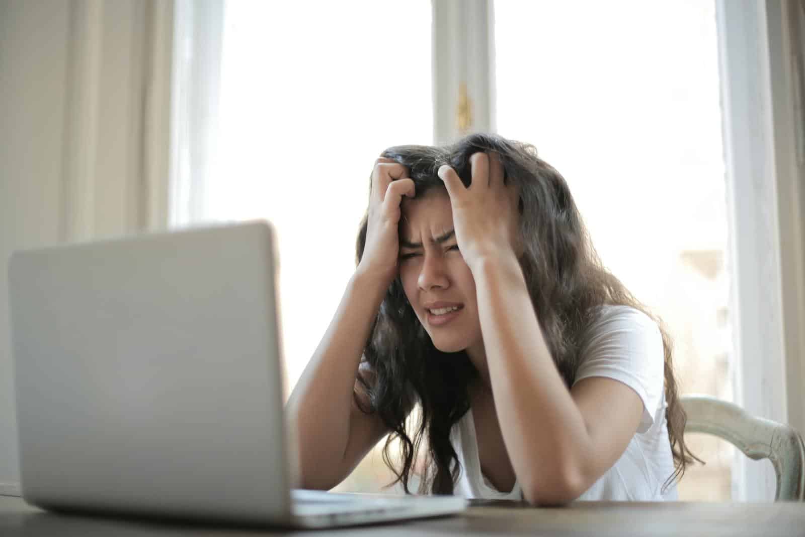 Managed WordPress Hosting, Website, Development, Agency Hosting, Fast Website, Frustrated woman struggling with remote work stress and digital challenges indoors.