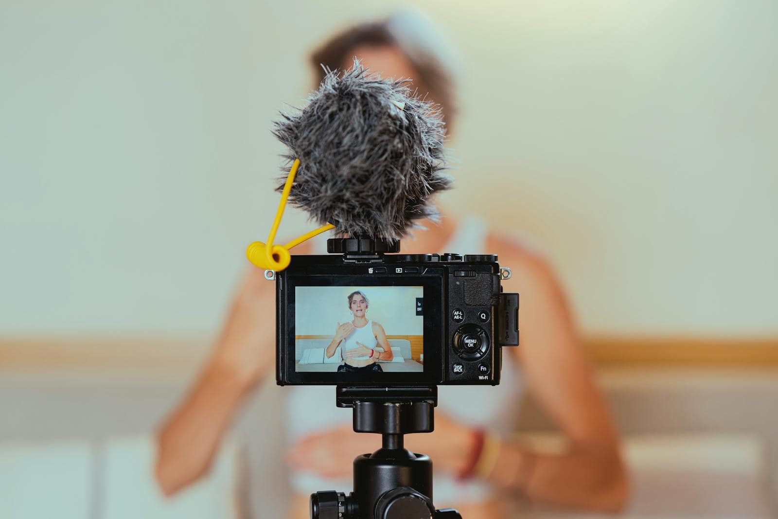 Video marketing, influencer, Elderly woman engages in vlogging using camera and microphone, embracing modern technology.